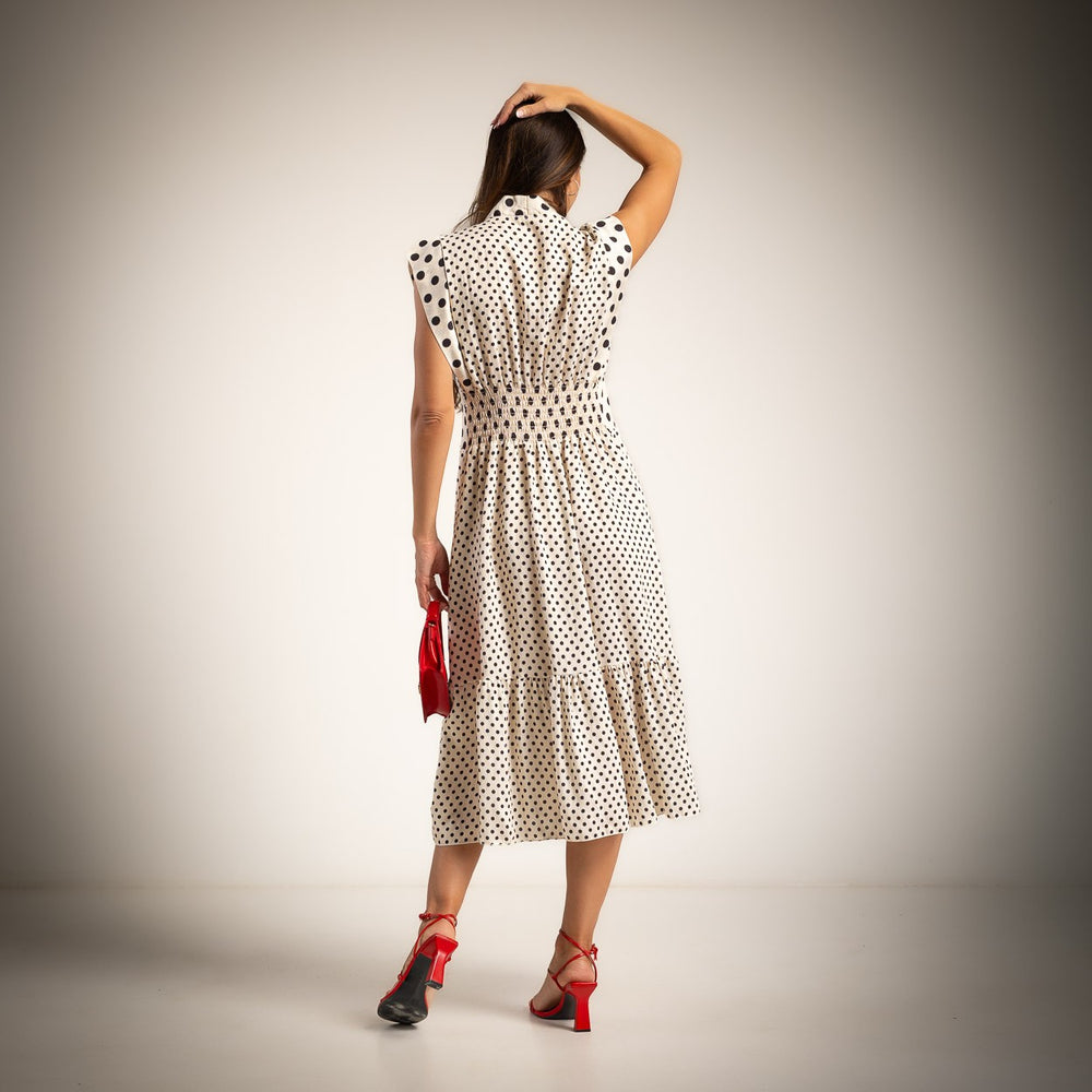 Back view of ivory white polka dots midi dress with elasticated waist and feminine midi length