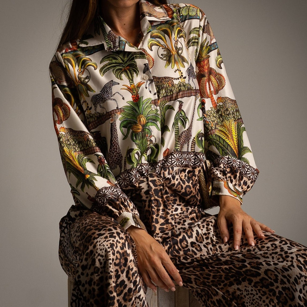Ivory white safari print shirt with tropical jungle motif paired with leopard print wide-leg trousers