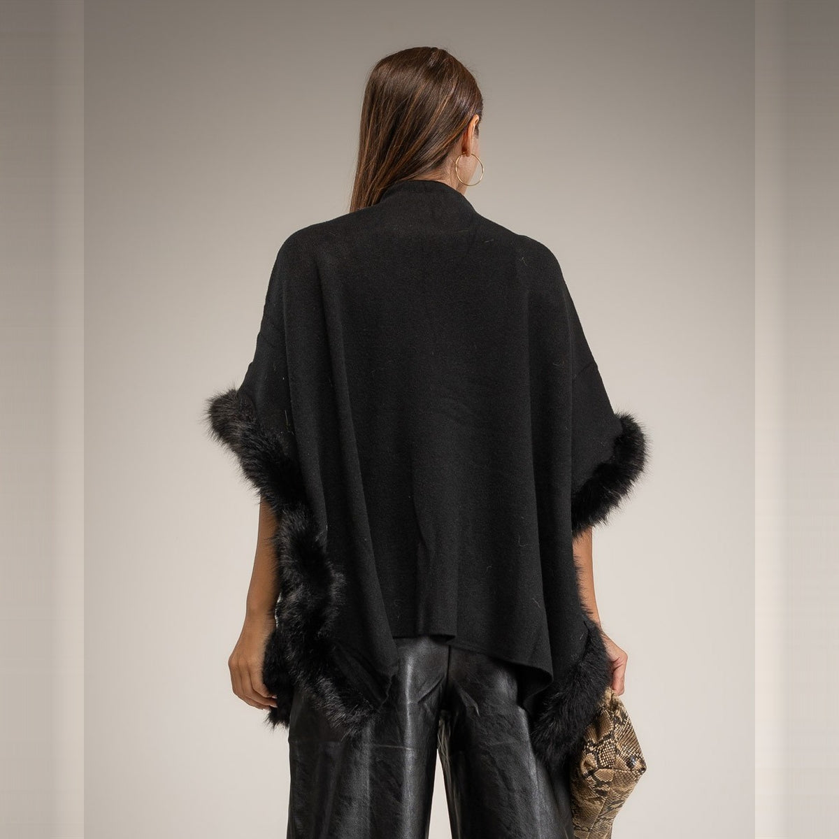 Black knit poncho with faux fur trim and mock neck - back view
