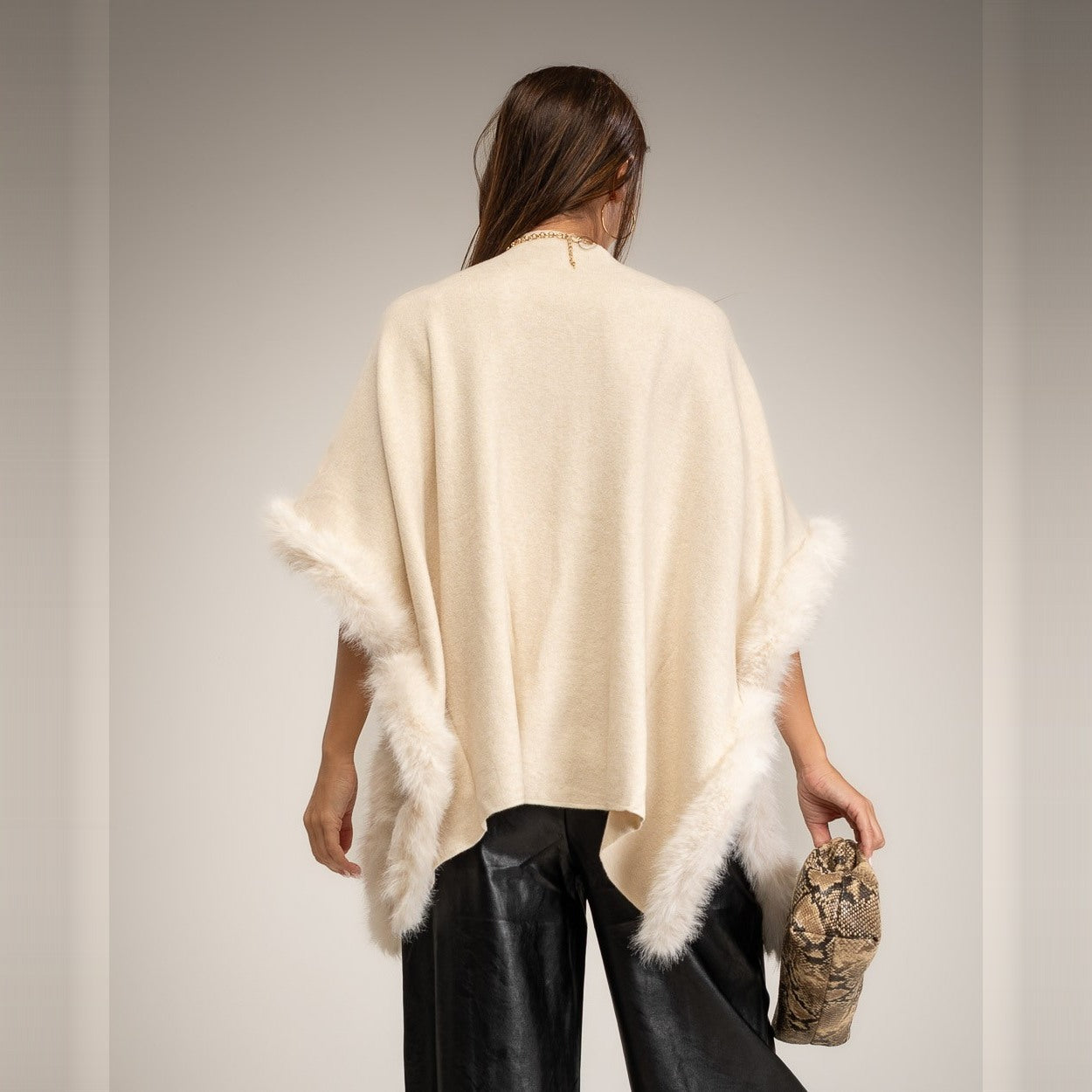 Latte Beige knit poncho with faux fur trim and mock neck - back view