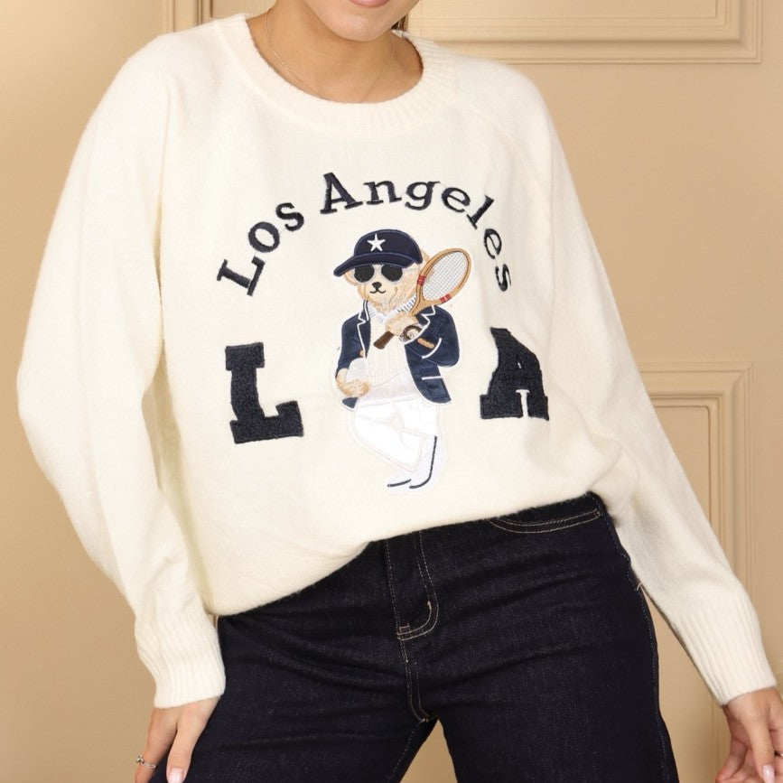 Ivory White knit sweater with embroidered tennis bear and Los Angeles varsity lettering - front view