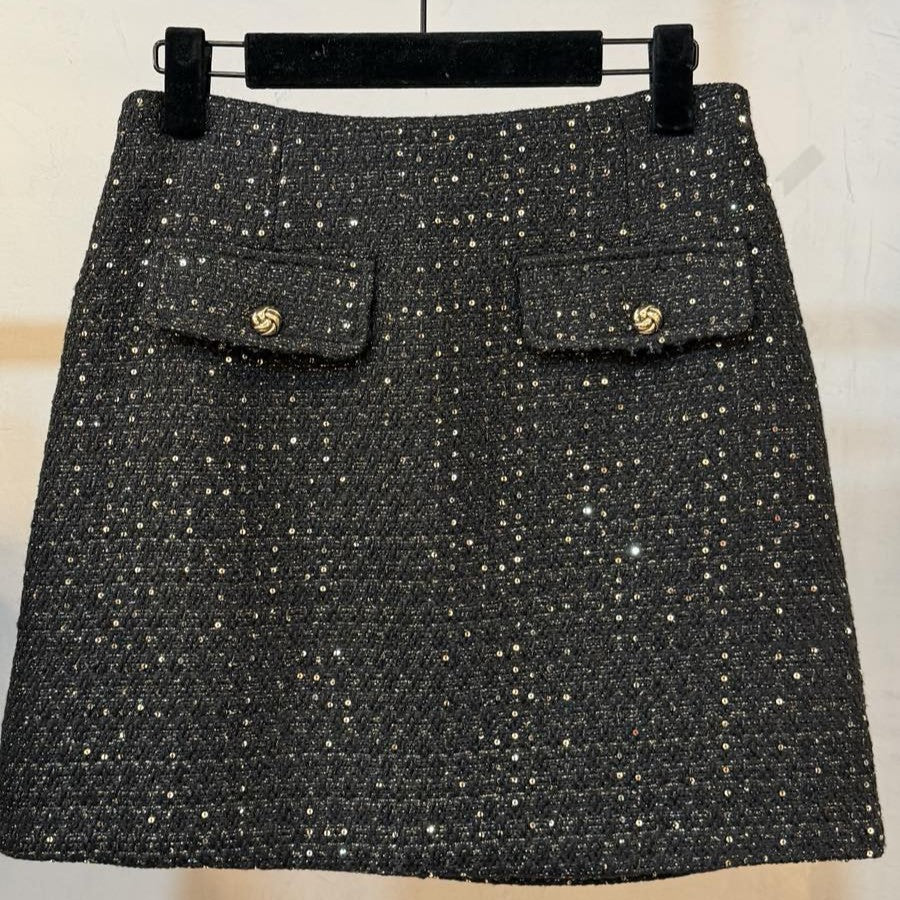 Black sequin tweed mini skirt with gold knot buttons and two flap pockets - front view