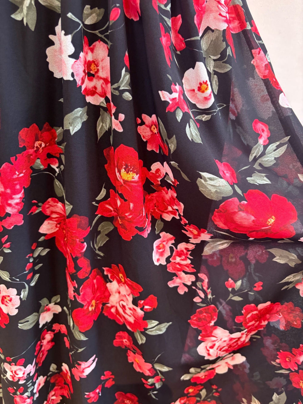 Close-up of midnight bloom floral print featuring red and blush roses on a black background
