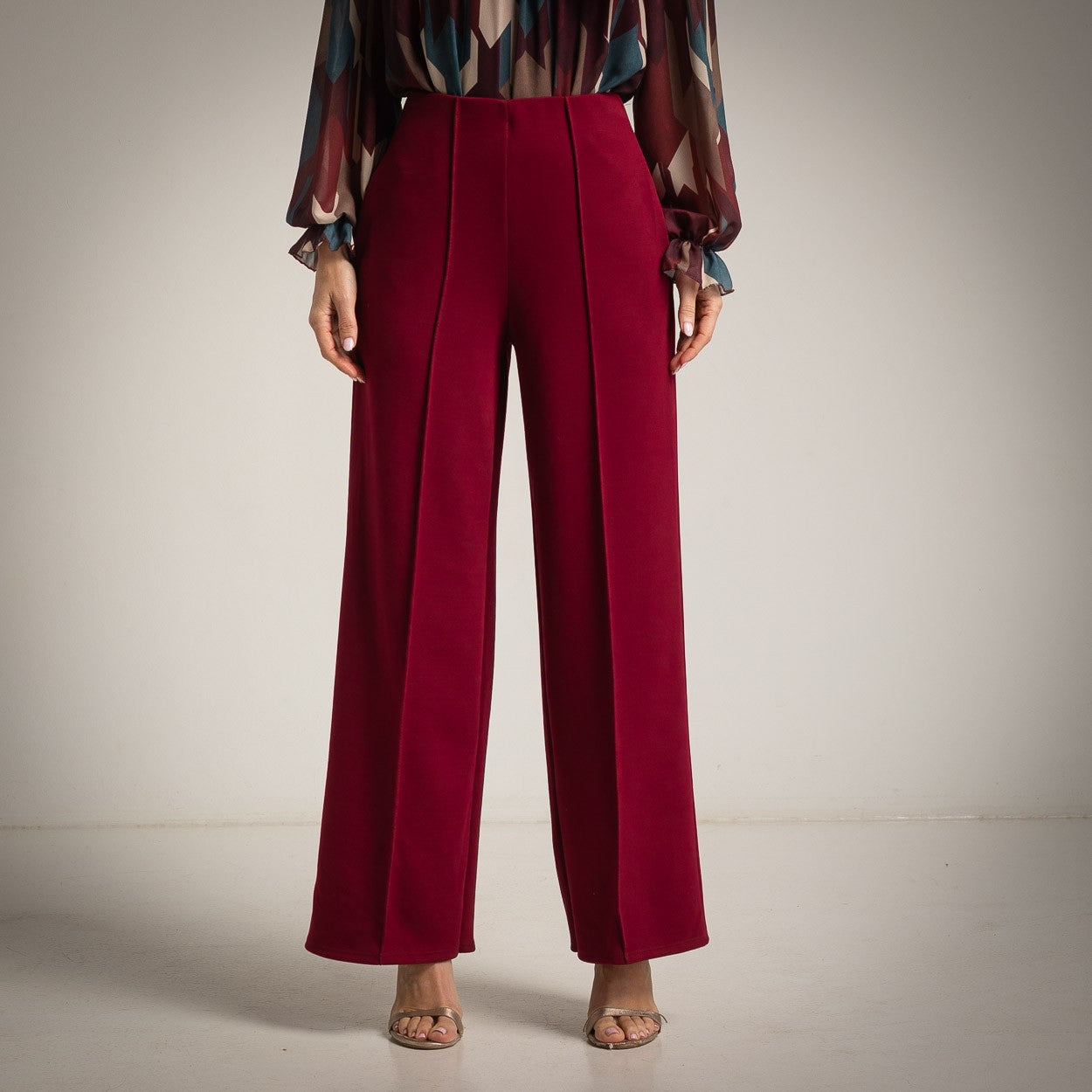 Deep Wine Red high-waisted flared trousers with a pressed centre seam - front view