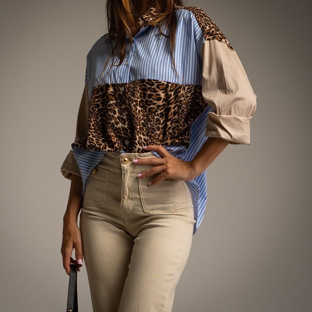 Front detail of MARIΓIOÚ leopard and striped oversize blouse styled with beige trousers