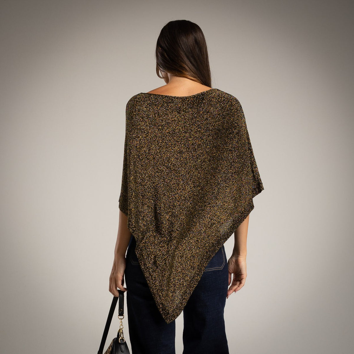 Black asymmetric lurex poncho with shimmering metallic knit - back view
