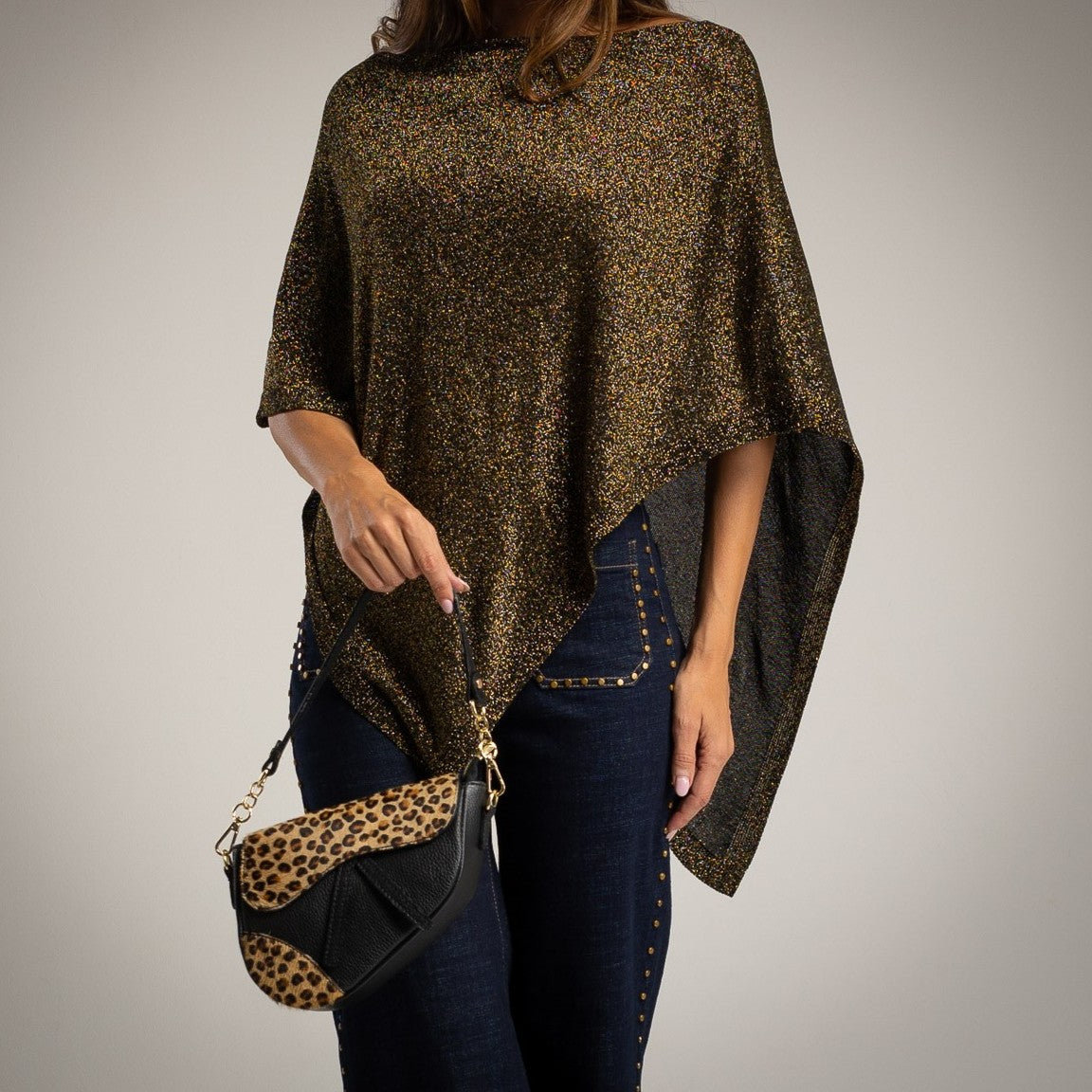 Black asymmetric lurex poncho with shimmering metallic knit - front view