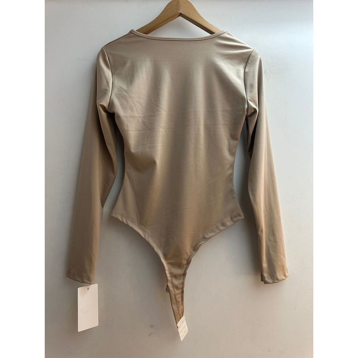 Latte Beige long sleeve bodysuit with V-neck and gold ring twist front - back view