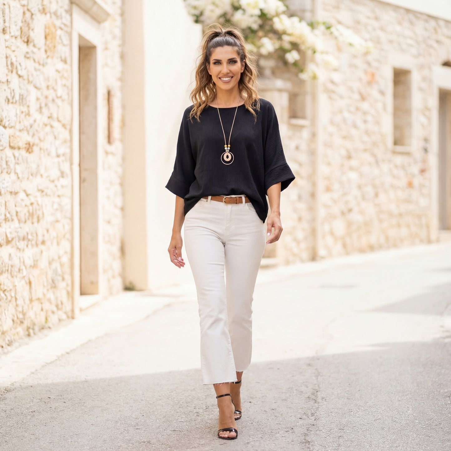 Black oversized shirt by MARIΓIOÚ styled with beige trousers elegant city outfit