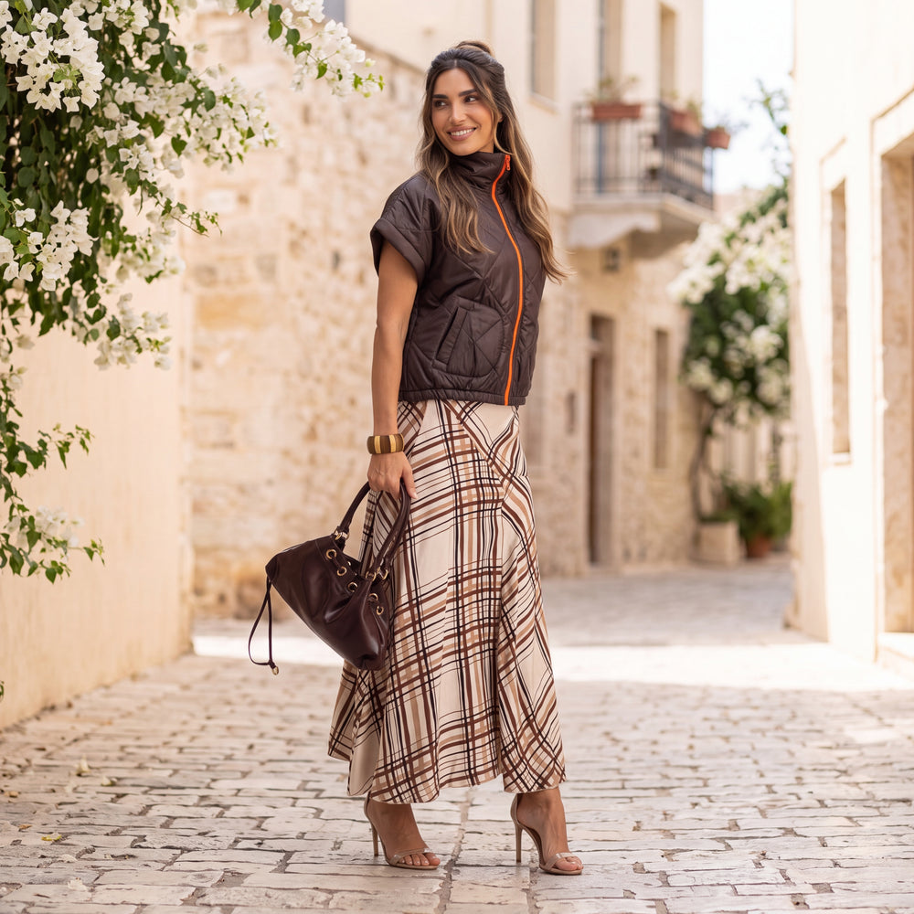 Woman wearing the MARIGIOU Padded Vest in Cocoa Brown styled outdoors with a chic autumn look.
