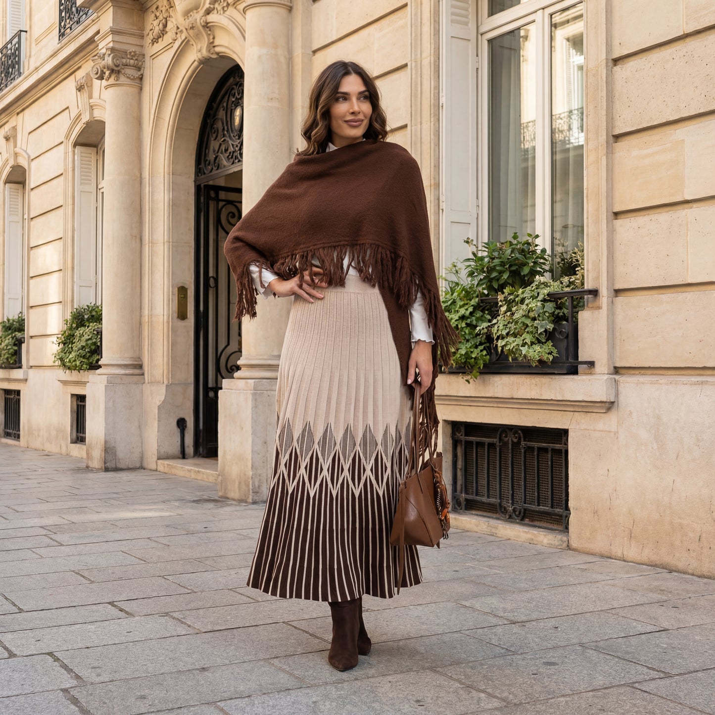 Beige pleated knit midi skirt styled with fringed chocolate scraf