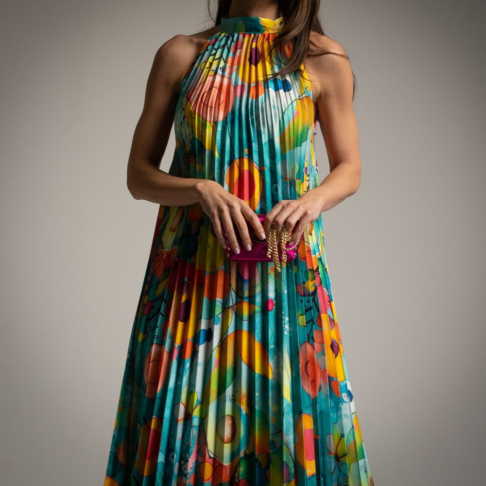 Detail of MARIΓIOÚ pleated satin halter midi dress in turquoise highlighting colorful abstract pattern and satin texture