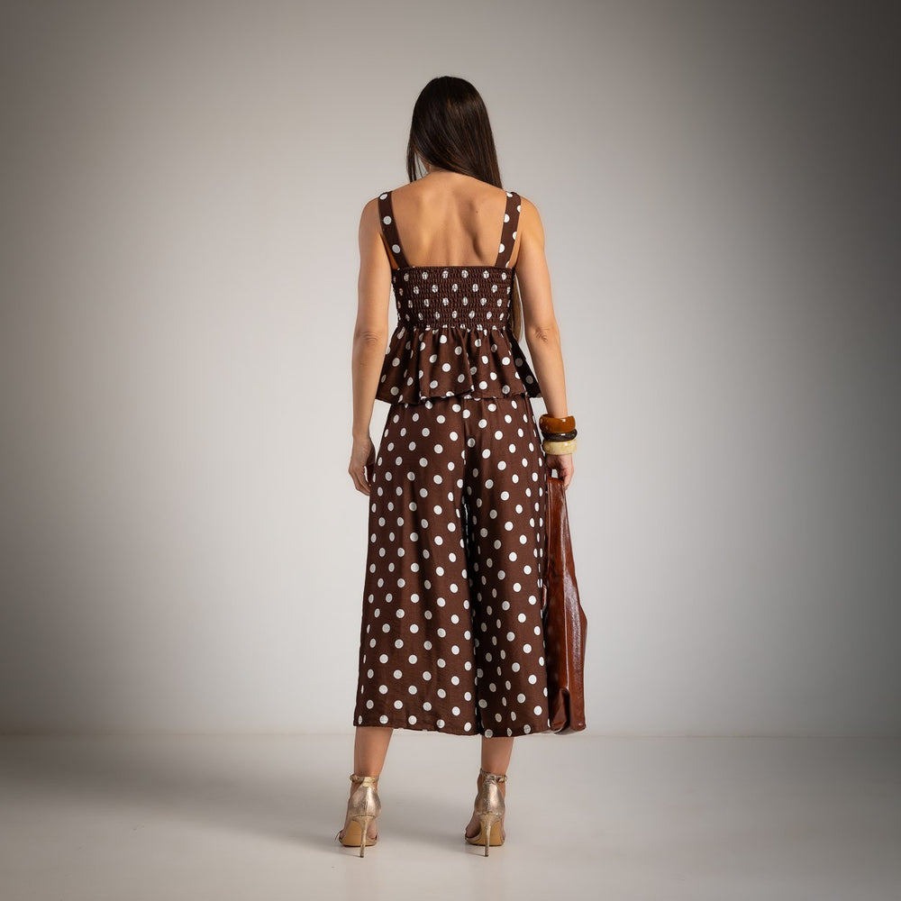 Back view of chocolate brown polka dot peplum top and wide leg pants set
