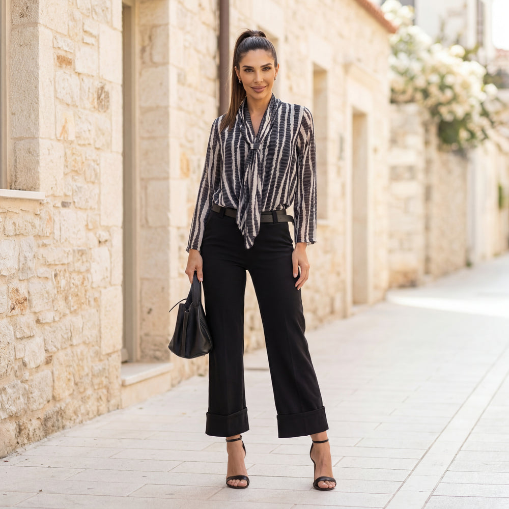 Black printed tie-neck blouse styled with black trousers chic city outfit