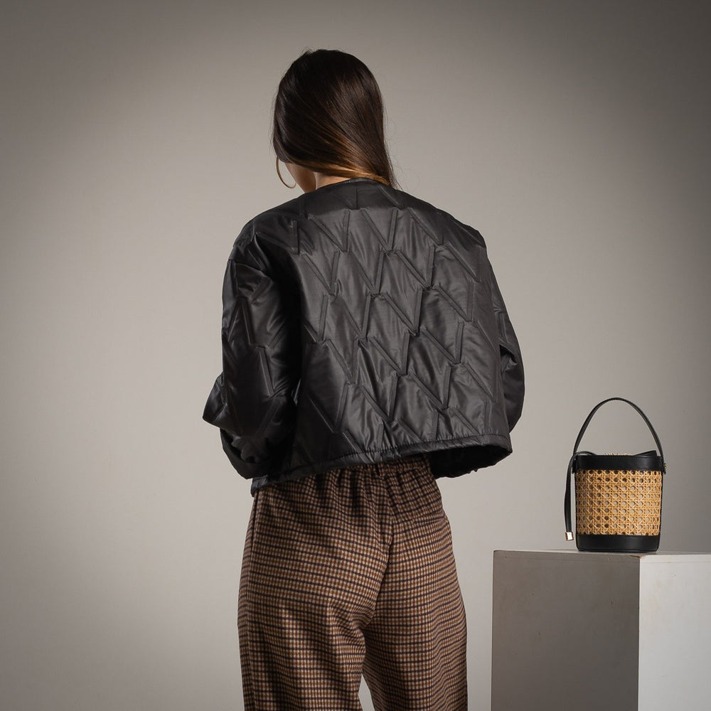 Black quilted jacket with clover brooch back view