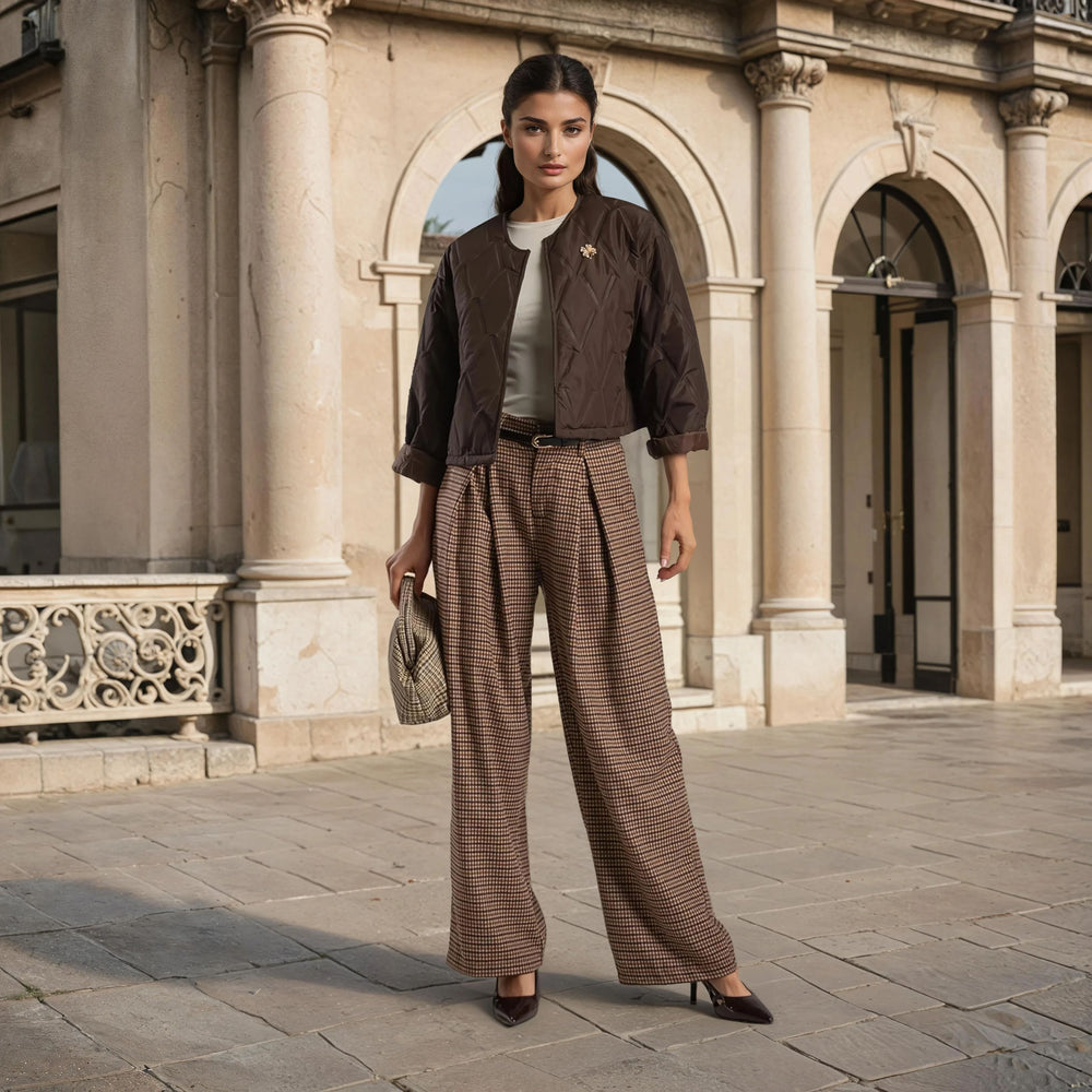 Chocolate quilted jacket with clover brooch styled with beige top and checked pants