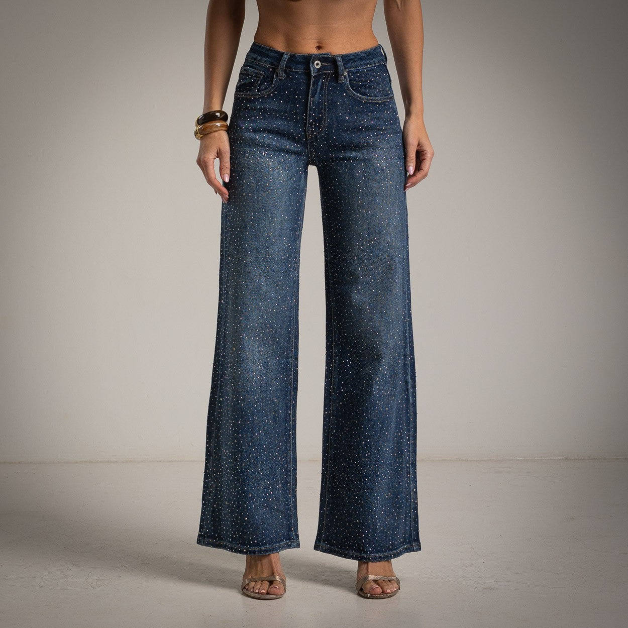 Dark blue wide leg jeans with rhinestone embellishment by MARIΓIOÚ front view