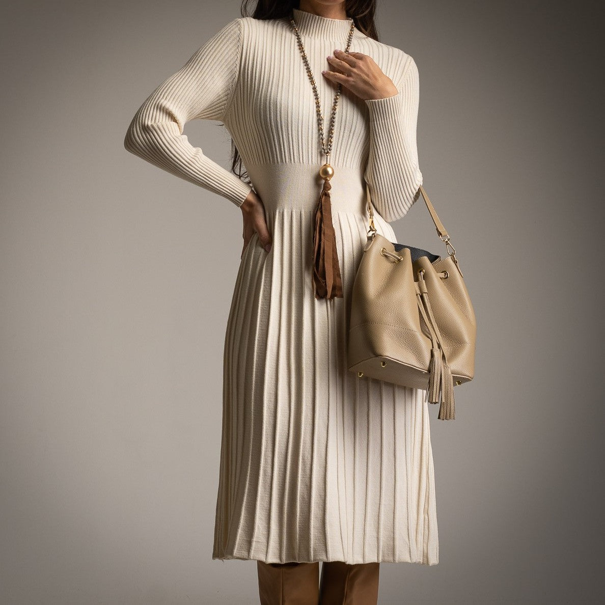 Creme ribbed knit dress by MARIΓIOÚ with pleated skirt detail