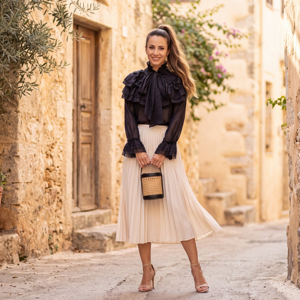 Black ruffle blouse with tie bow neck and flounced cuffs by MARIΓIOU