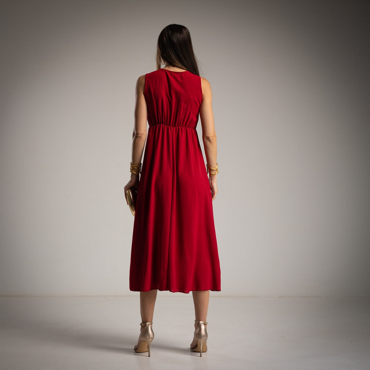 Ruby Red sleeveless asymmetrical midi dress back view with elegant draped silhouette