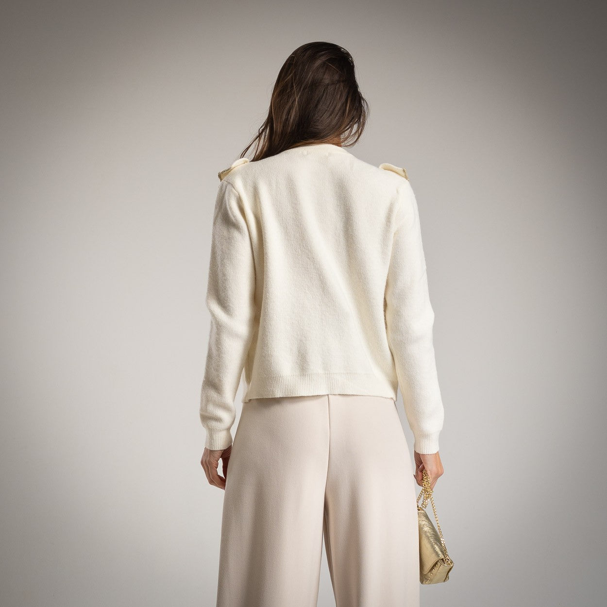 Back view of elegant knit cardigan with ruffle detail