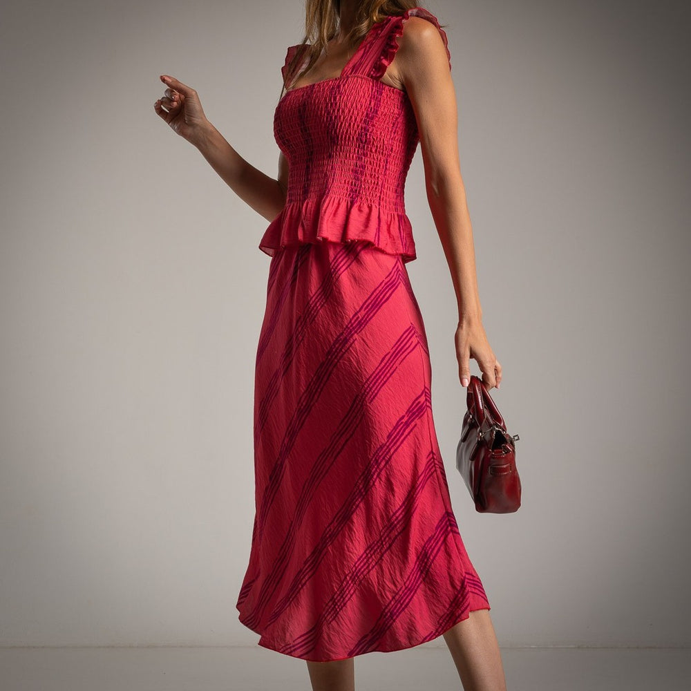 Raspberry pink ruffled smocked top and midi skirt set, side view