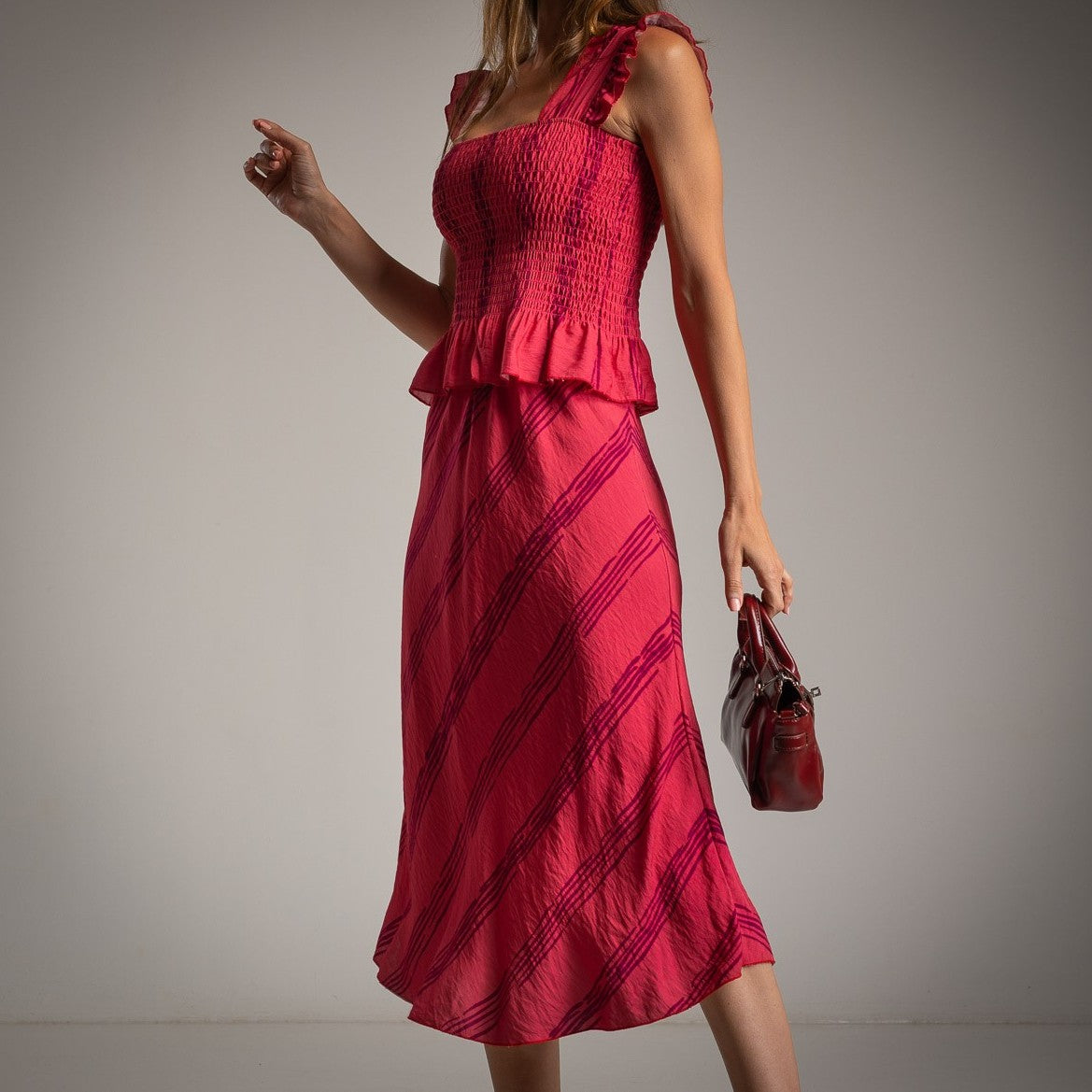 Raspberry pink ruffled smocked top and midi skirt set, side view