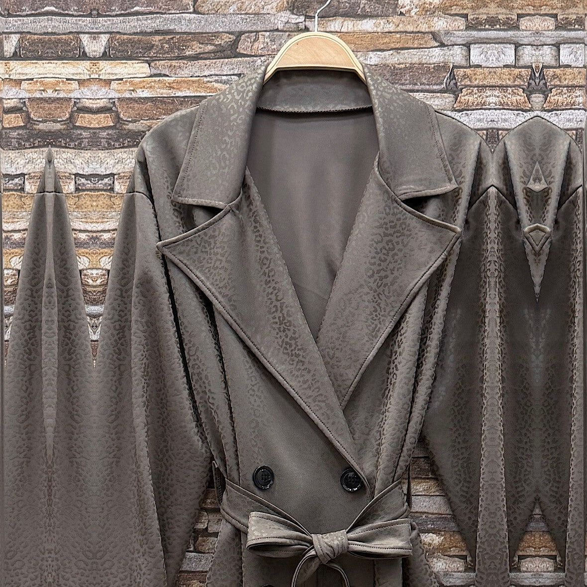 Almond Taupe embossed leopard trench coat with wide lapels and tie belt - detail view