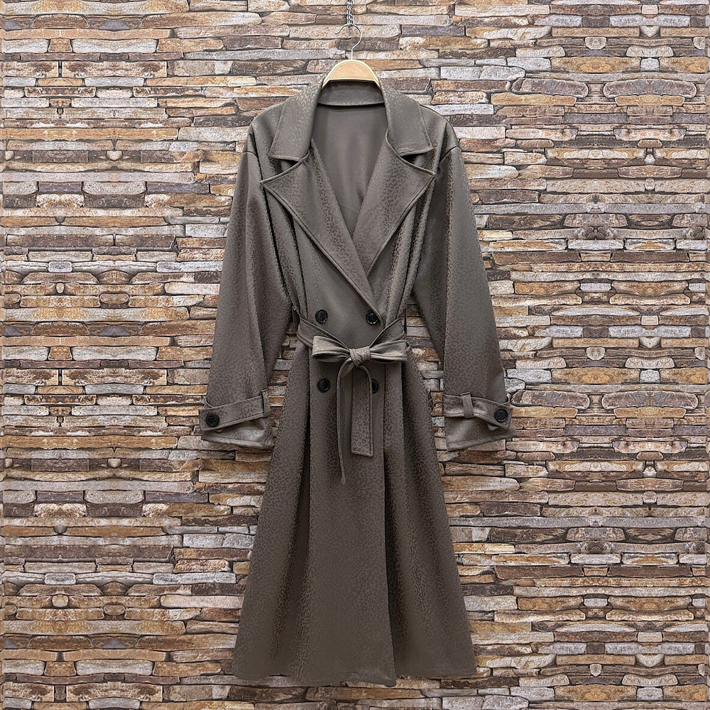 Almond Taupe embossed leopard trench coat with wide lapels and tie belt - front view