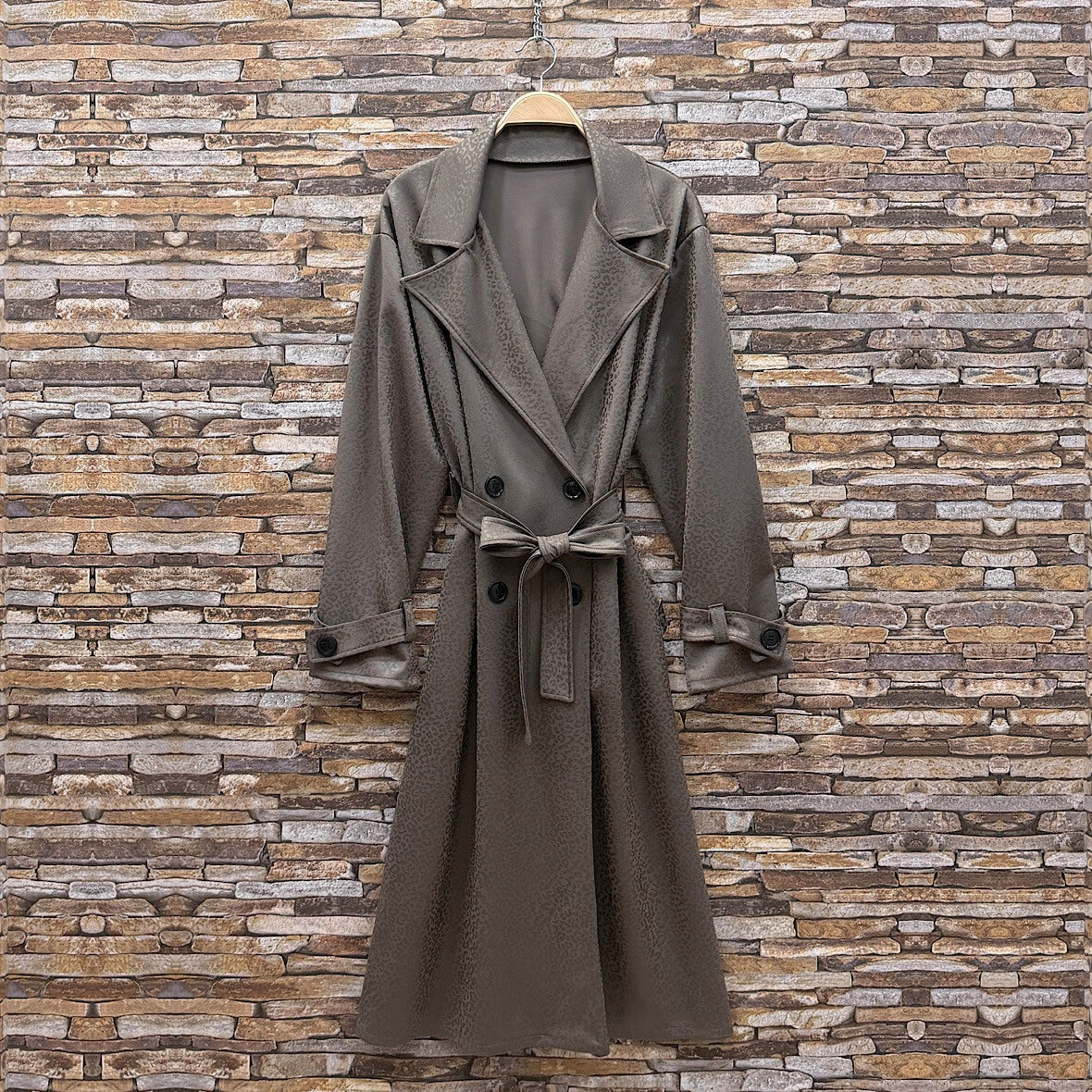 Almond Taupe embossed leopard trench coat with wide lapels and tie belt - front view