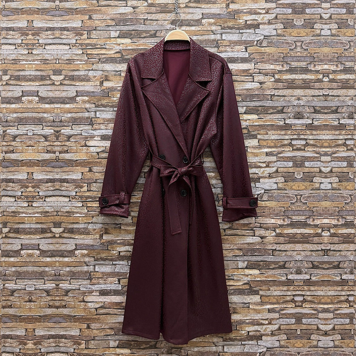 Deep Wine Red embossed leopard trench coat with wide lapels and tie belt - front view