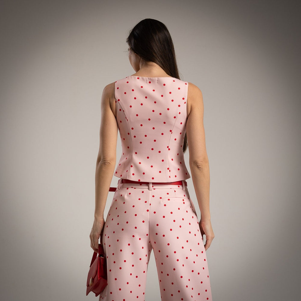 Back view of soft blush pink polka dots tailored vest with elegant fitted design