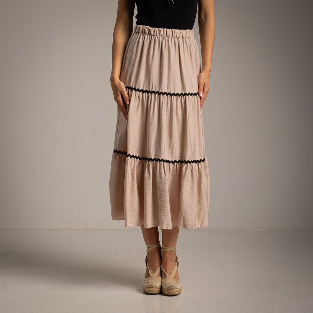 Elegant soft sand beige tiered midi skirt with black trim front view