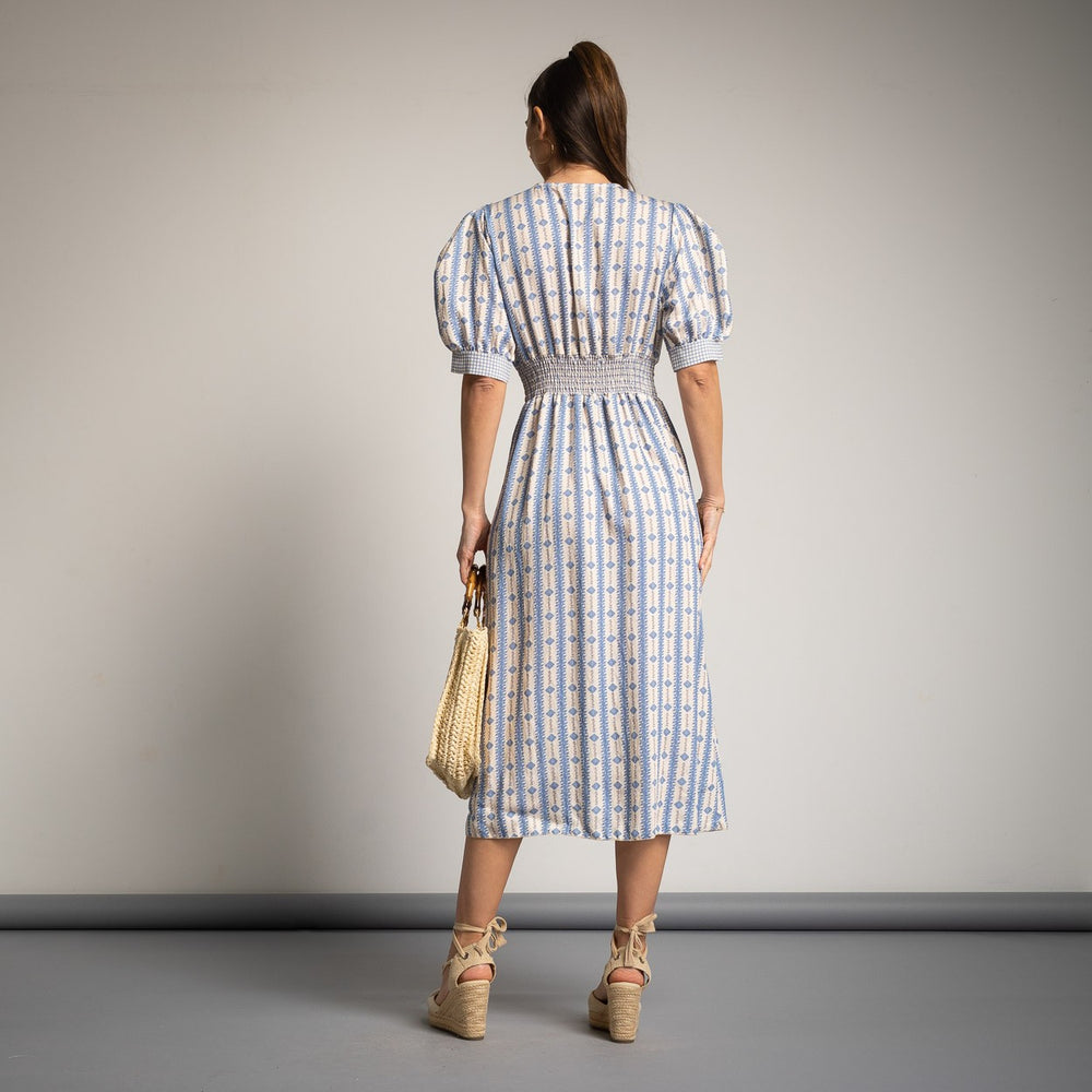 Back view of MARIΓIOÚ blue spring midi dress with smocked waist detail