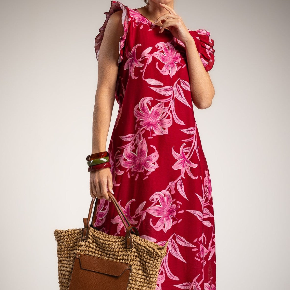 Front detail view of romantic floral midi dress in sunset fuchsia with feminine ruffle sleeves