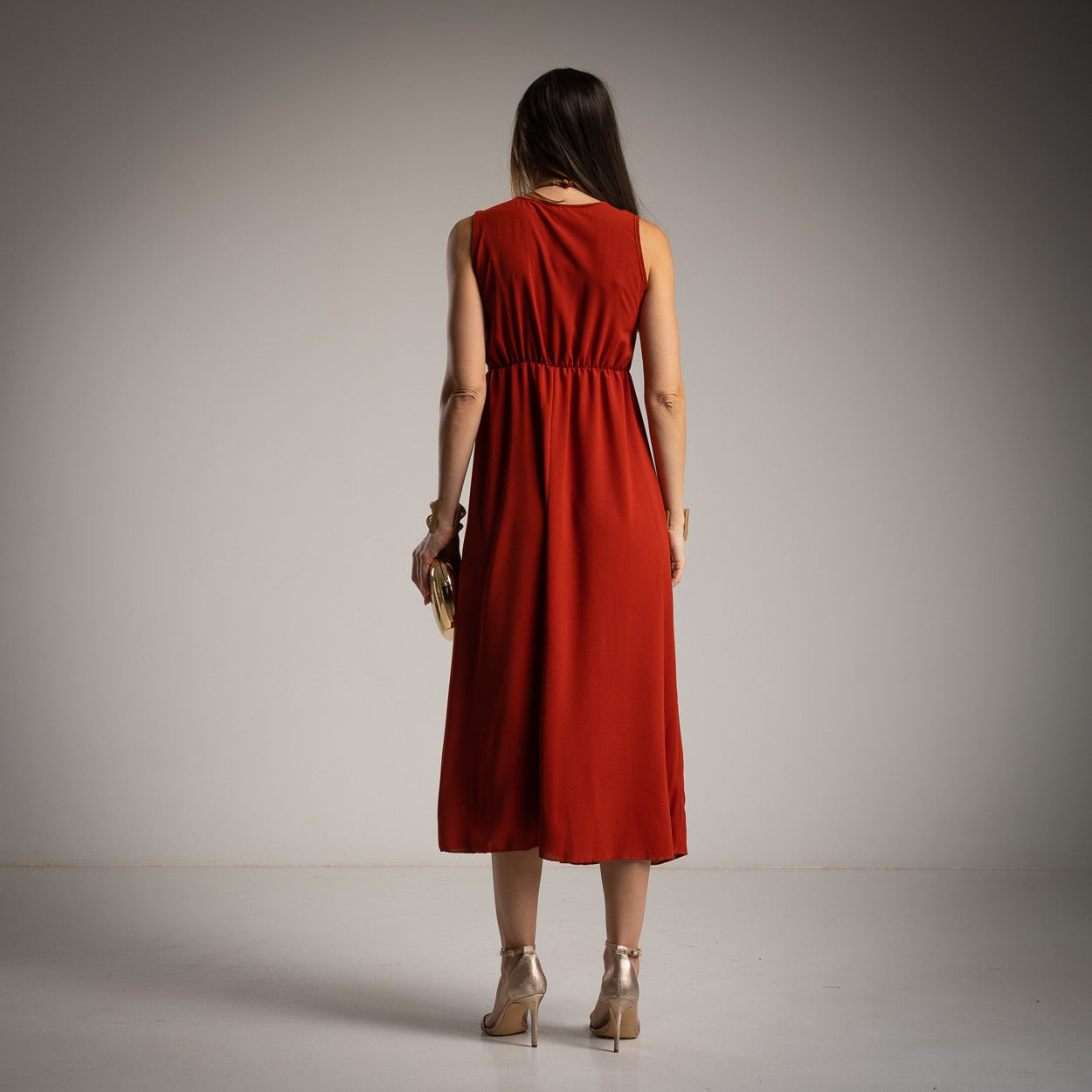 Teja sleeveless midi dress back view with flowing skirt and elastic waist detail