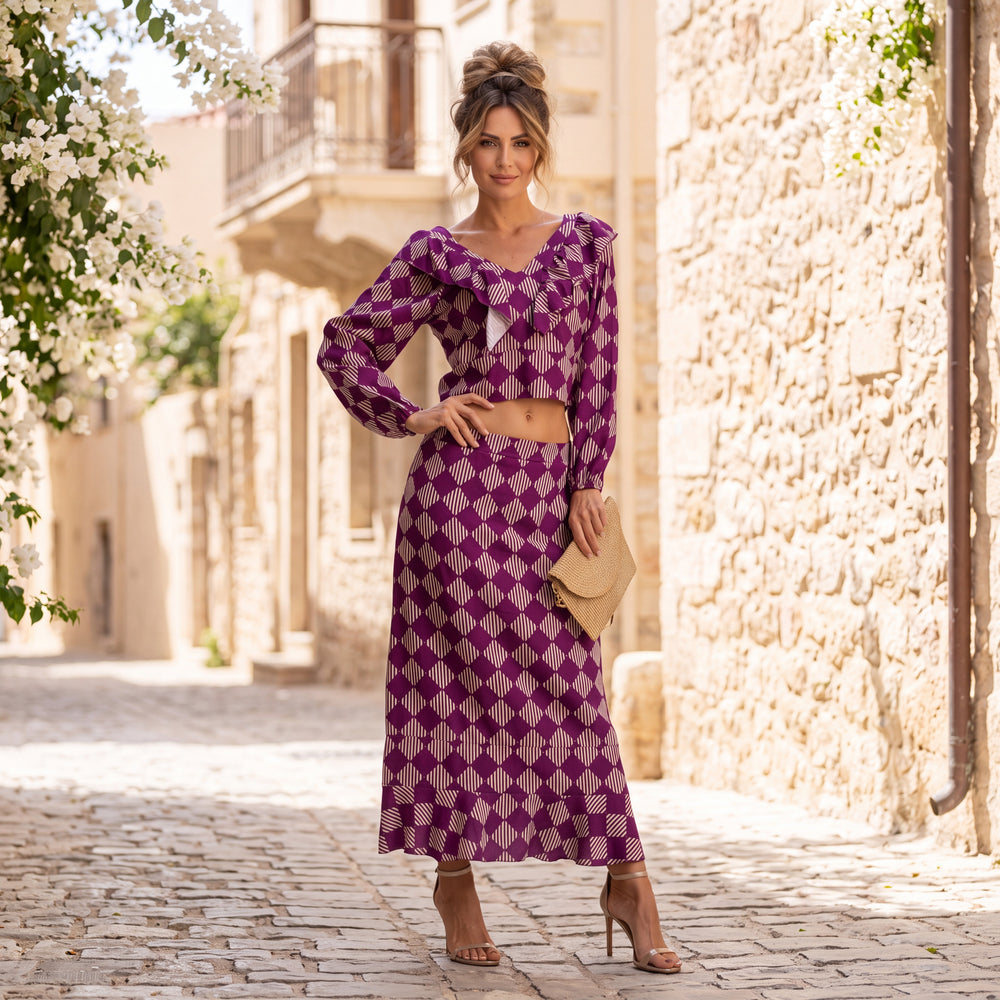 Woman wearing the Valentina printed two-piece set in Wild Berry with ruffle crop top and maxi skirt