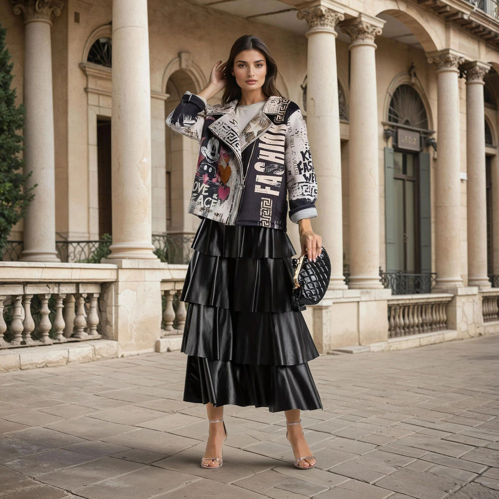 Model wearing MARIΓIOÚ Mickey neoprene jacket with tiered black skirt in urban setting.