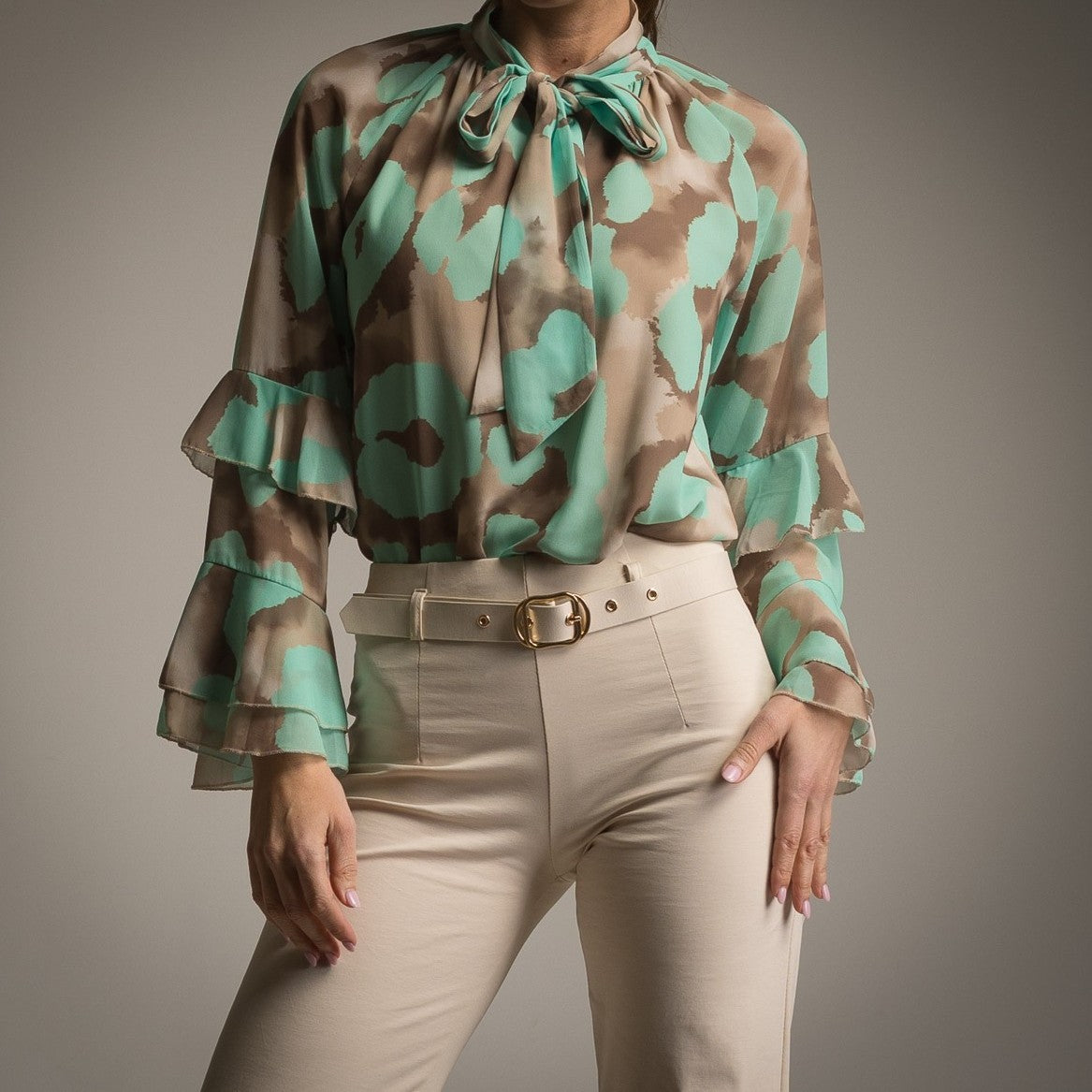 Close-up of mint and beige watercolour blouse with layered ruffle sleeves