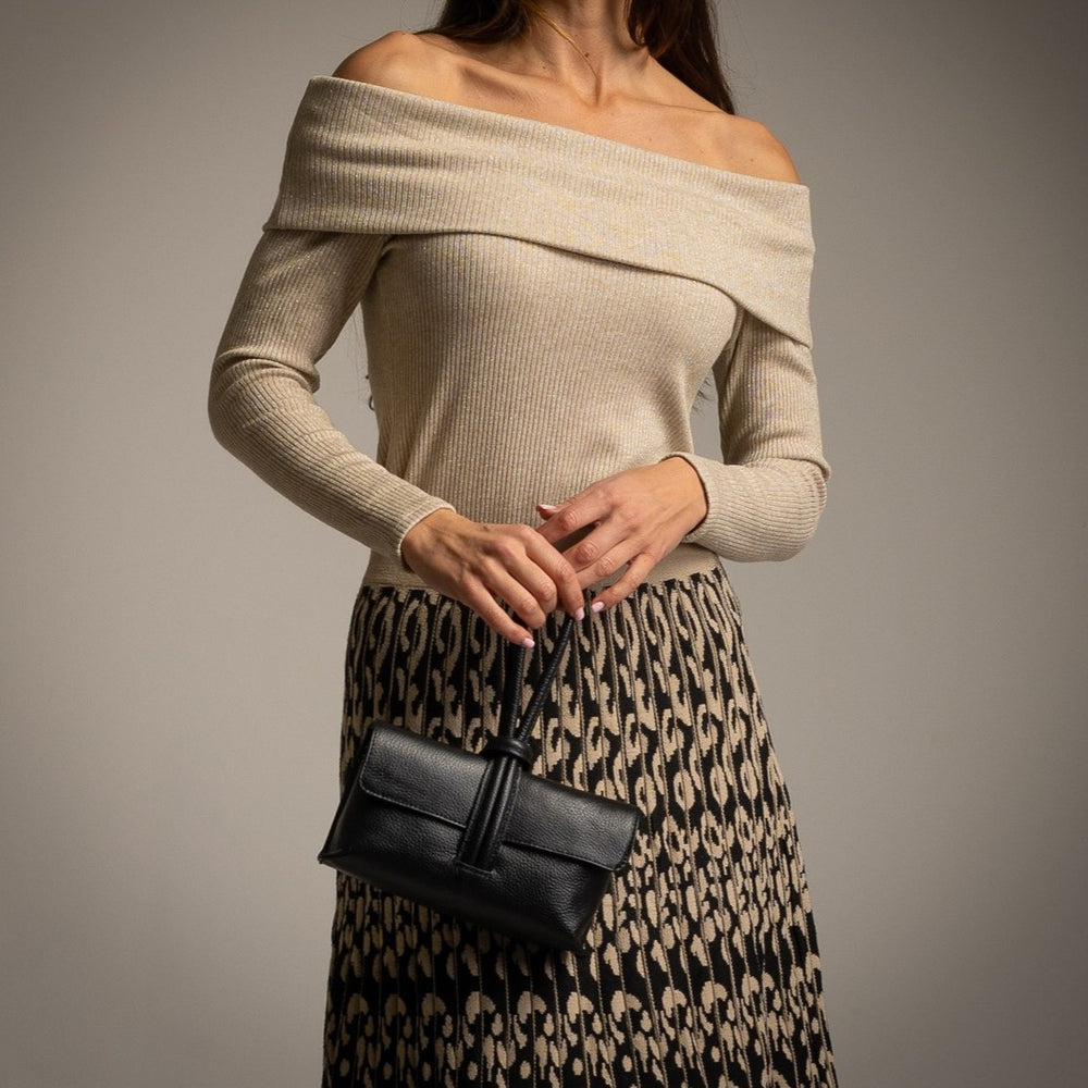 Beige off-shoulder knit sweater with subtle shimmer and long sleeves