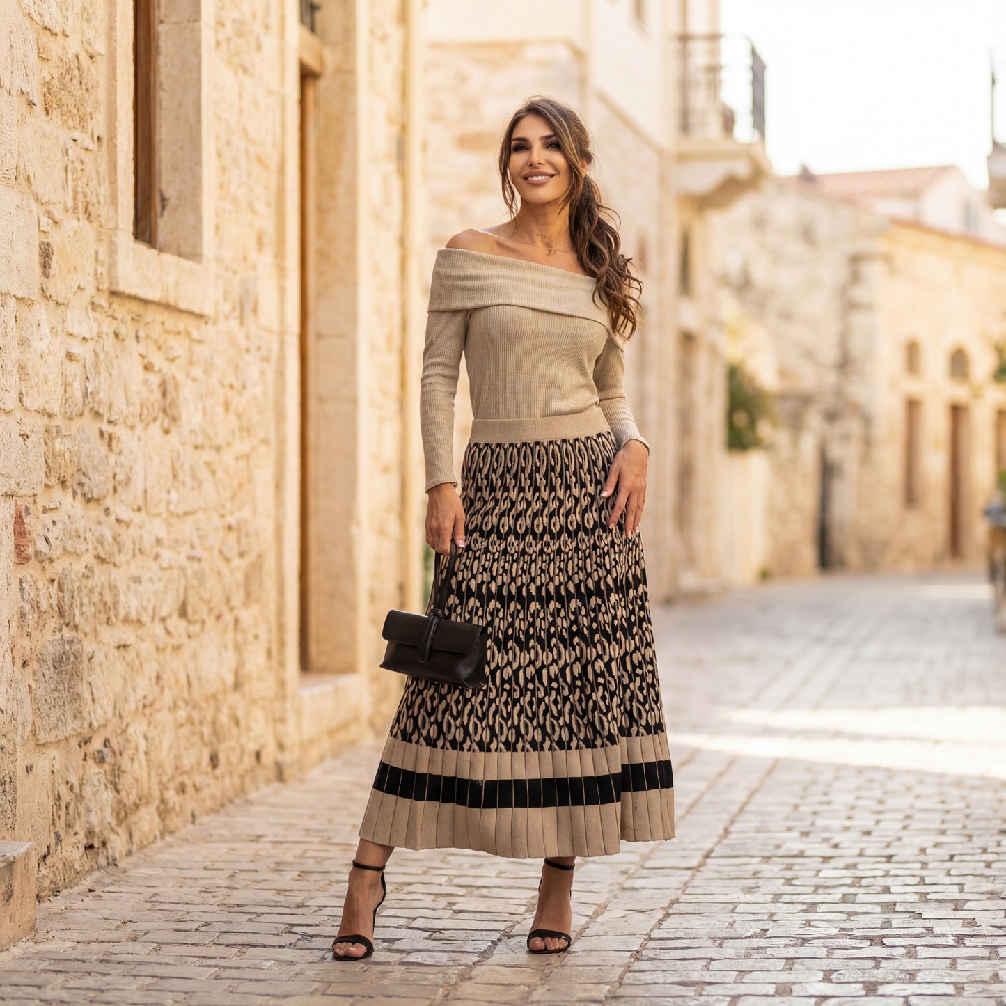 Beige off-shoulder shimmer knit sweater styled with pleated skirt
