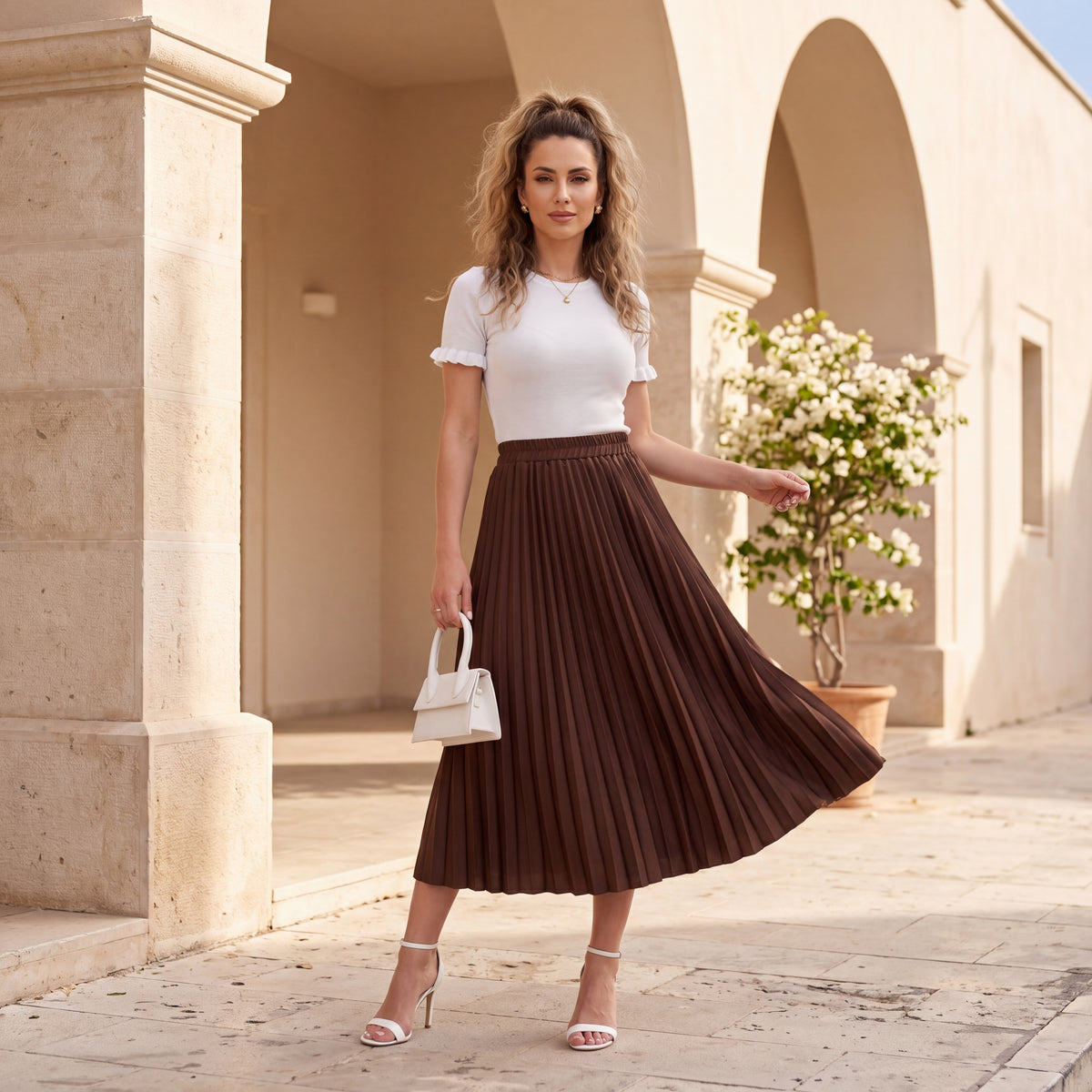 Woman wearing Pleated Satin Midi Skirt in Chocolate with white top and elegant summer styling