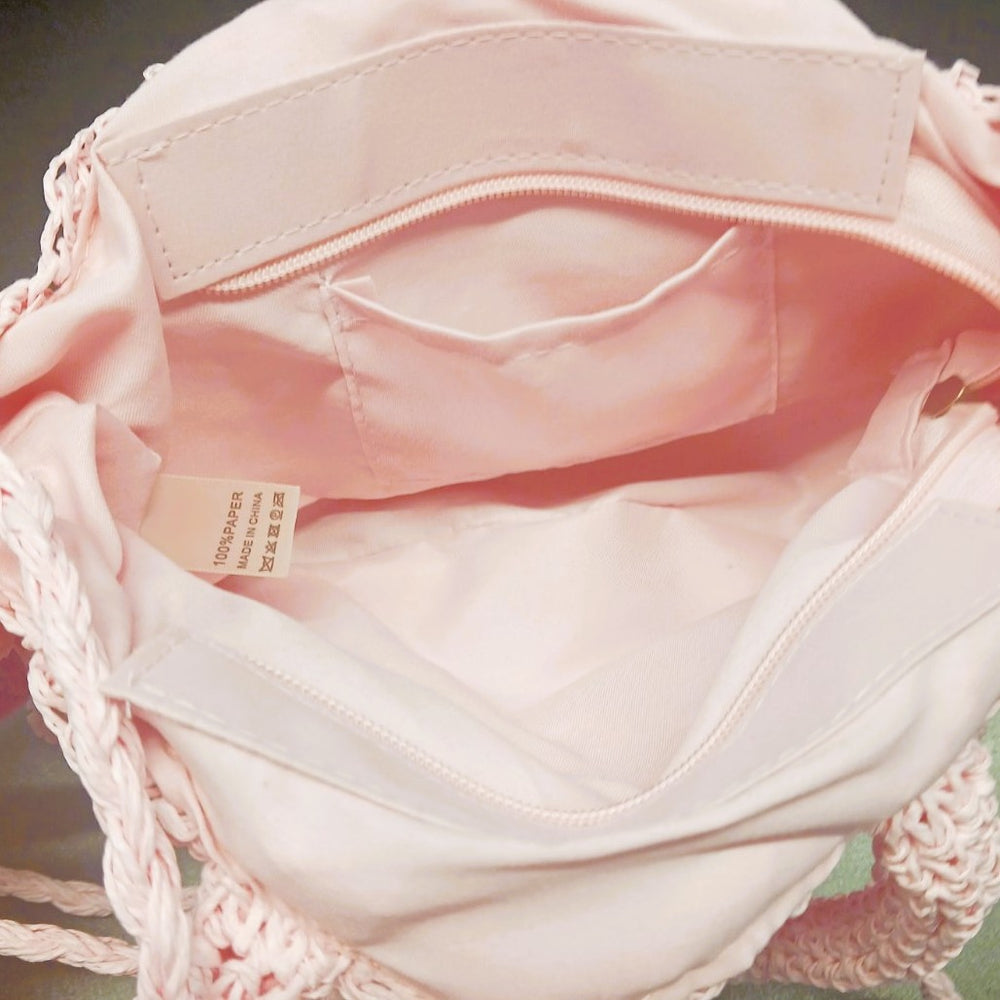 Interior view of the Pom Pom Beach Bag featuring a secure zip closure and storage pocket