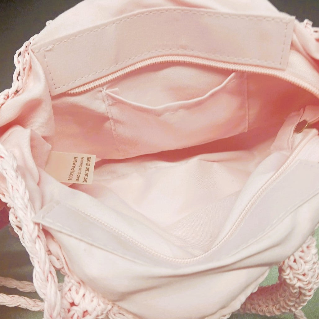 Interior view of the Pom Pom Beach Bag featuring a secure zip closure and storage pocket