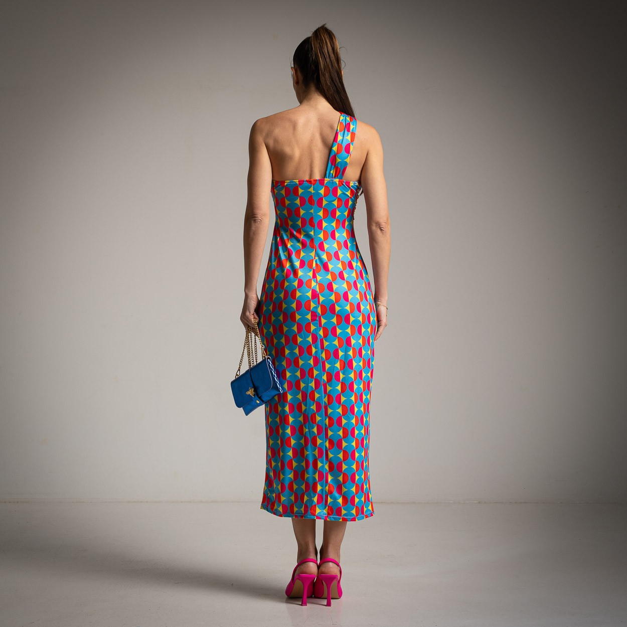 Yellow retro one-shoulder midi dress back view highlighting open back silhouette