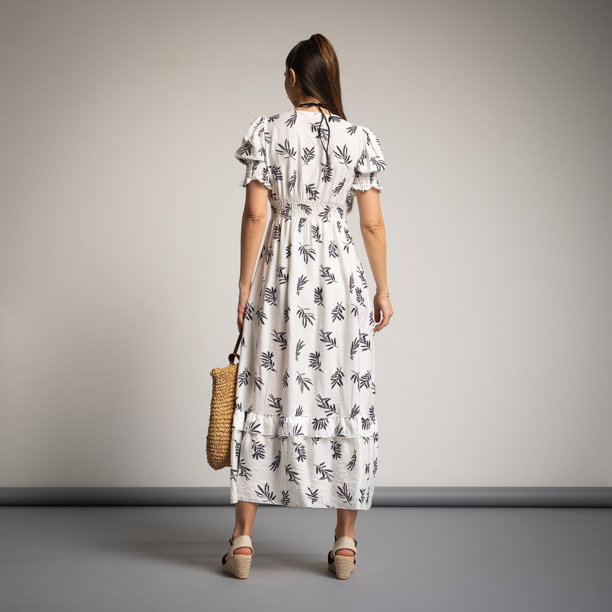 Romantic white midi summer dress with black leaf pattern, back view with smocked waist