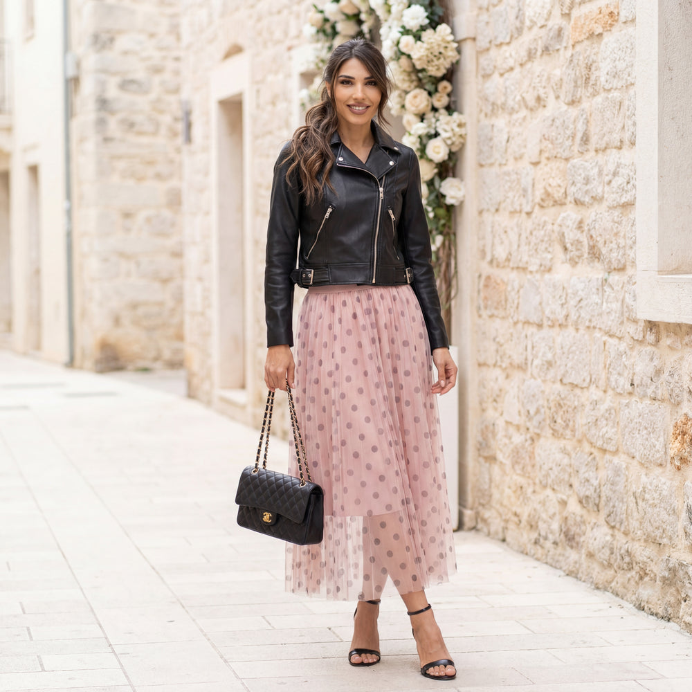 Rose tulle polka dot midi skirt worn outdoors with leather jacket