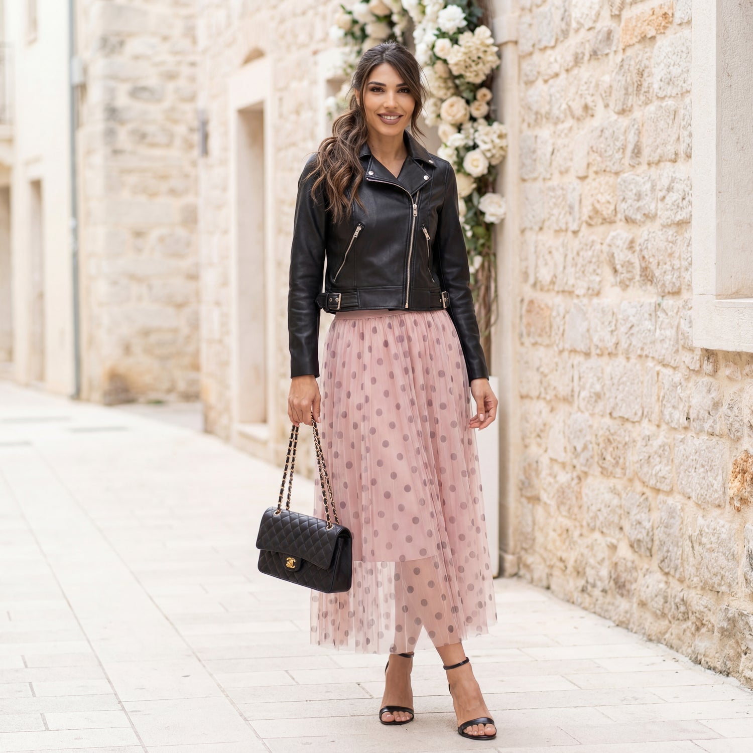 Rose tulle polka dot midi skirt worn outdoors with leather jacket
