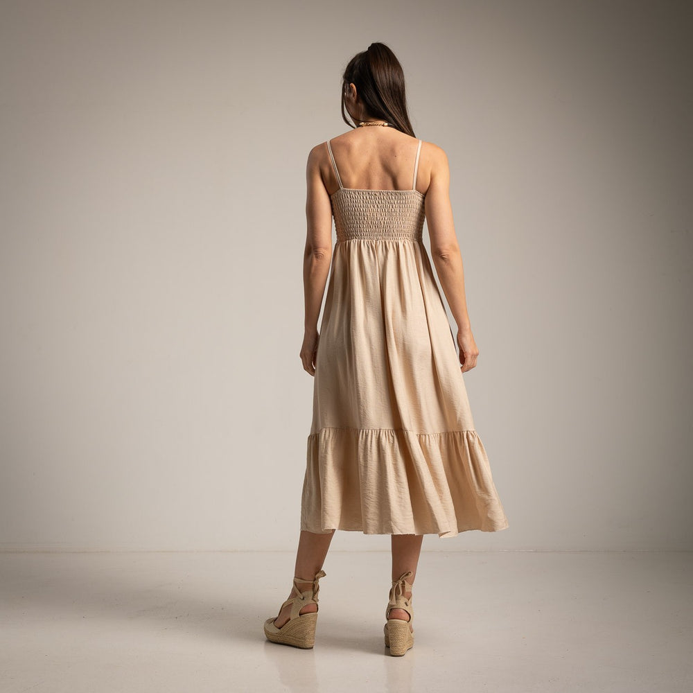 Back view of Soft Sand midi dress with smocked back and flowing silhouette