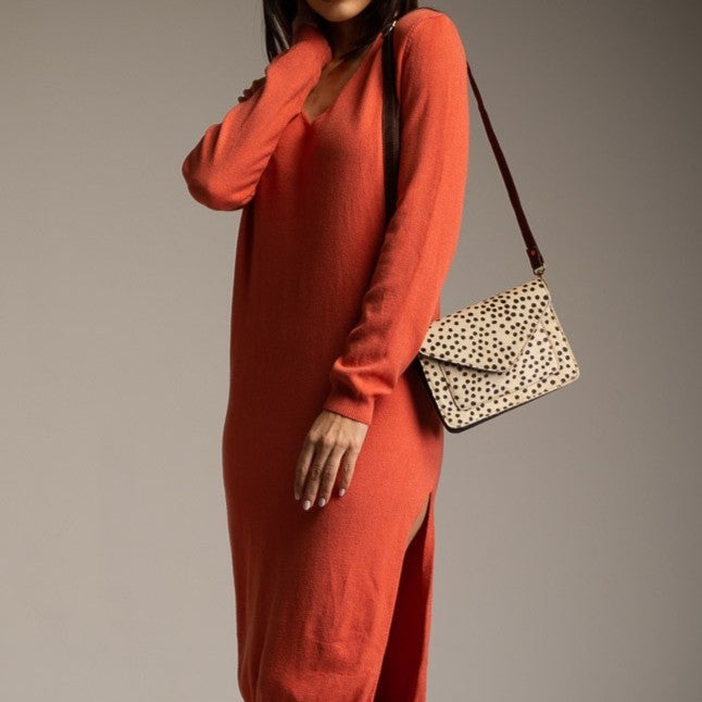 Spotted leather crossbody bag worn with casual outfit